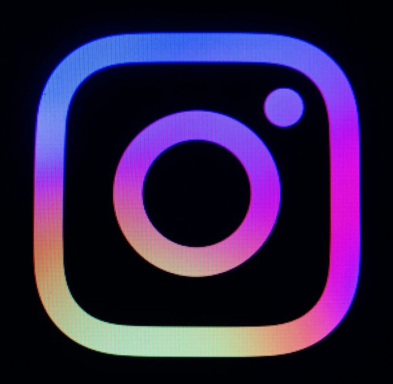 Instagram logo with colorful gradient on black